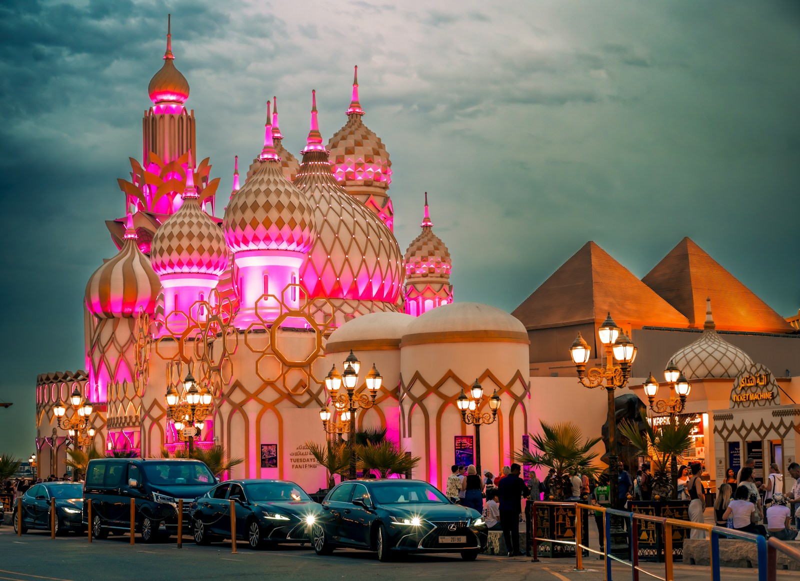 Fantasy architecture illuminated with pink lights at dusk.