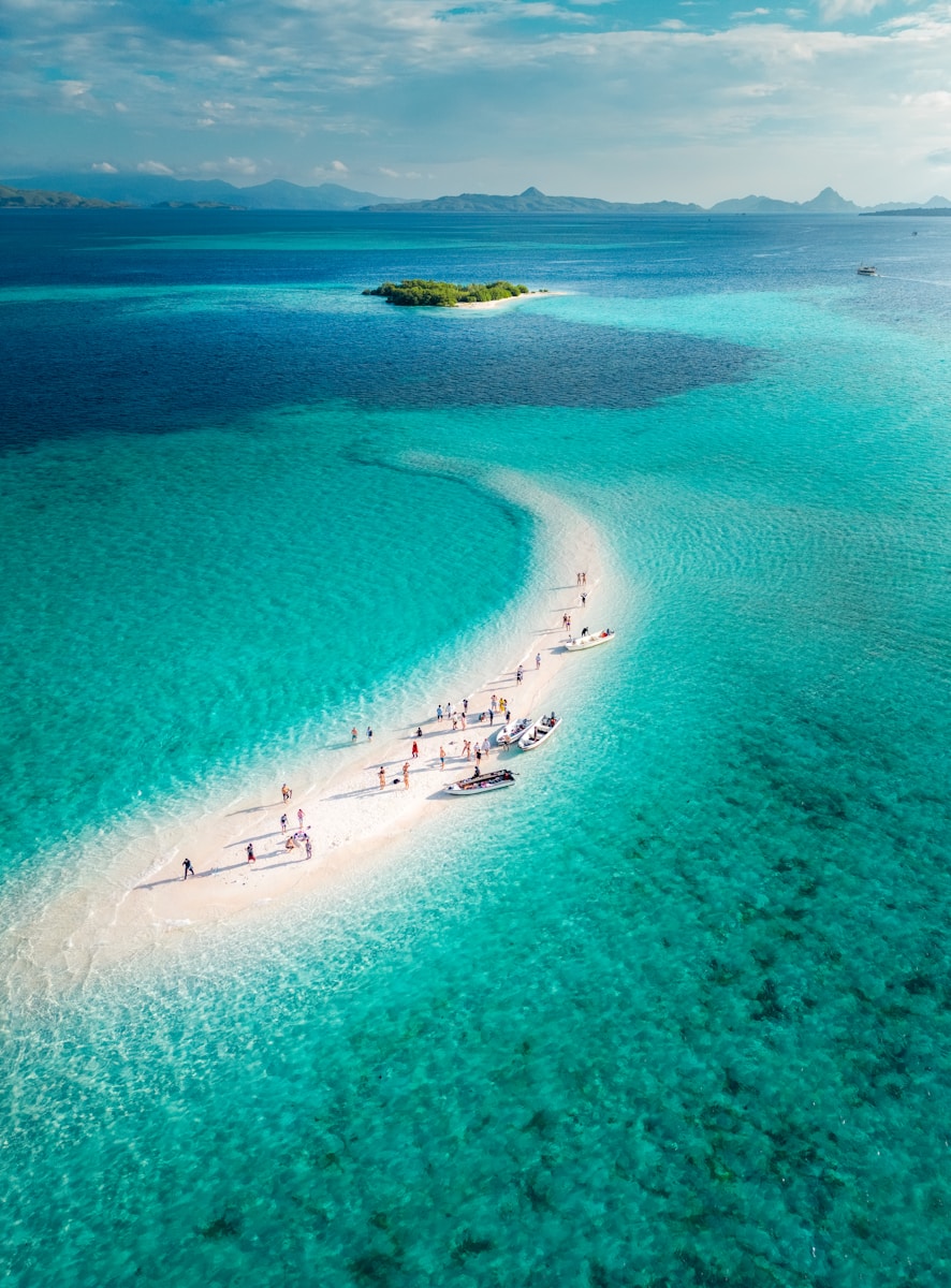 A group of people on a small island in the middle of the ocean