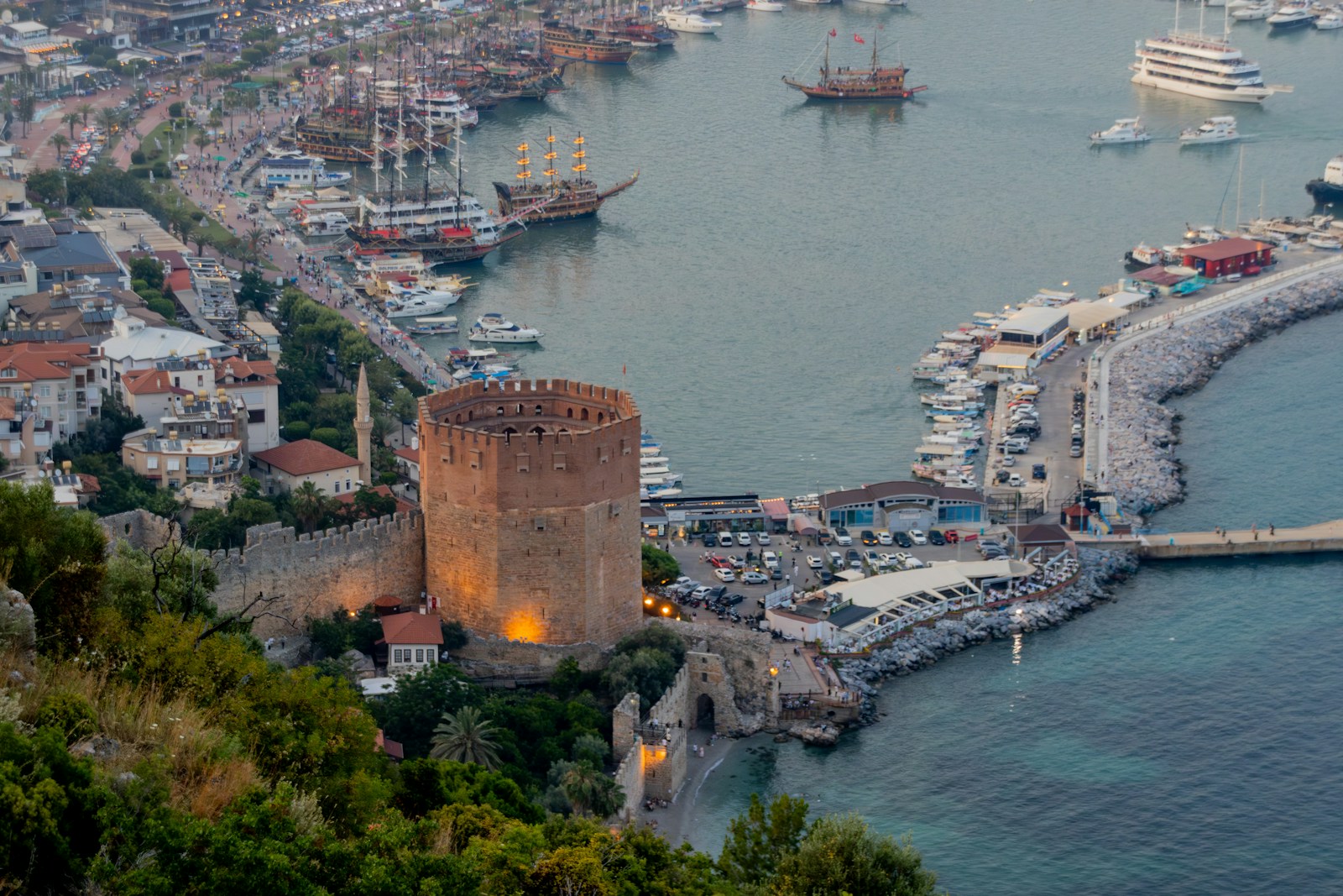 Coastal city with castle and harbor.