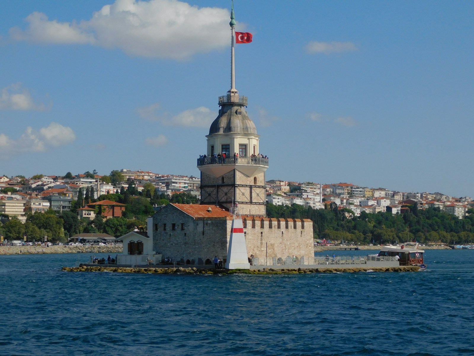 a large tower with a flag on top of it