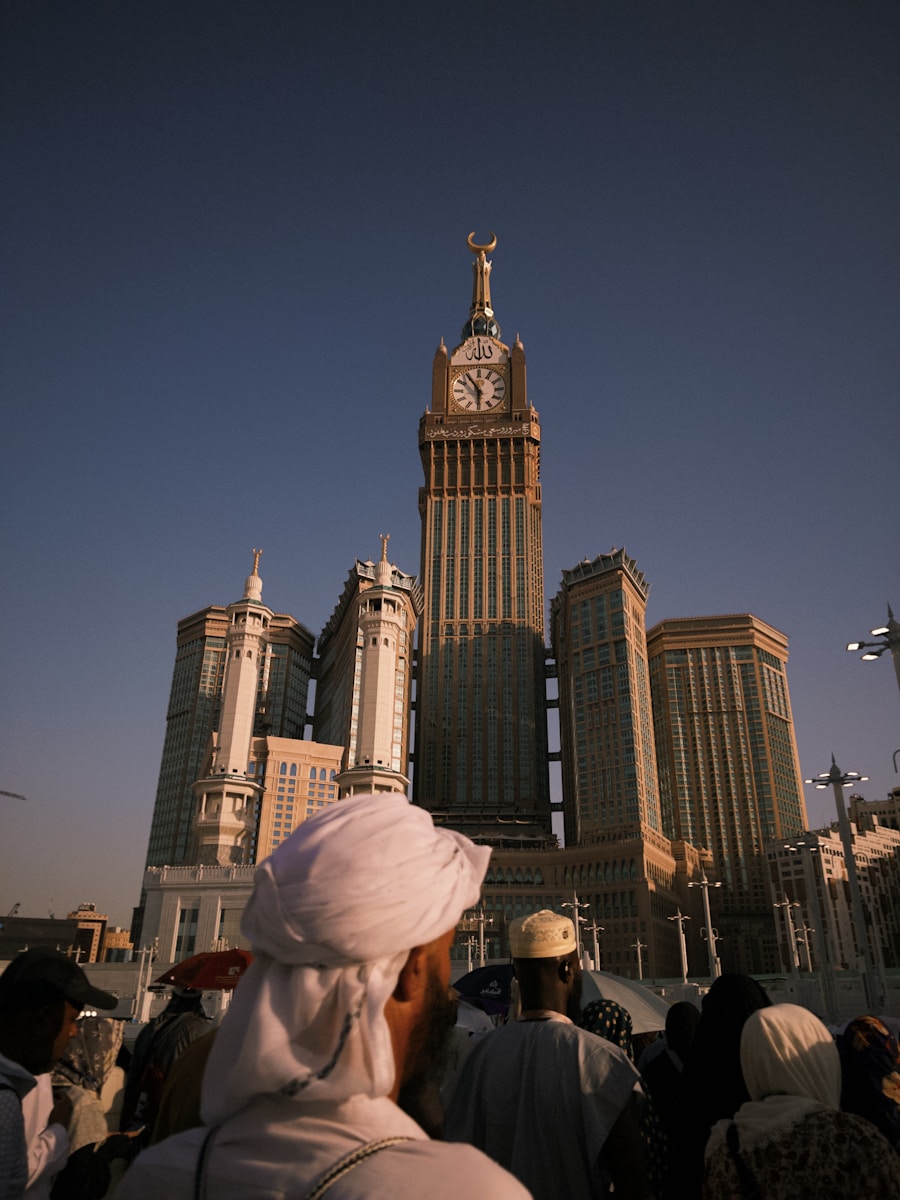 People stand before the abraj al-bait clock tower.