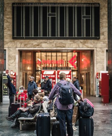 person standing beside the luggage bags